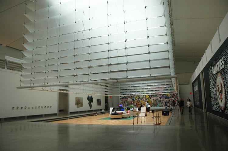 A glass cube like sculpture hangs in the entryway of the Queens Museum in Flushing