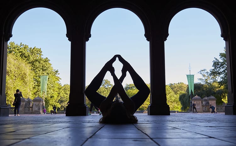 Michelle Della Giovanna from Full Time Explorer in a silhouette yoga pose