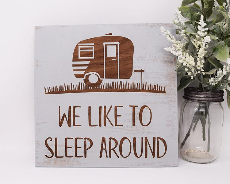 engraved wood sign with a RV camper that says, we like to sleep around