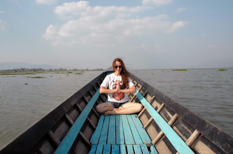 Michelle Della Giovanna from Full Time Explorer sits in a blue boat on Inle Lake in Myanmar