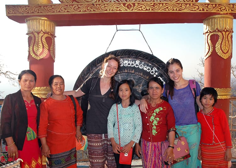 Michelle Della Giovanna from Full Time Explorer poses with a Burmese family in Myanmar