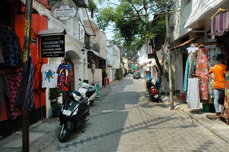 Colorful clothes hang outside of shops on Princess Street in Fort Kochi