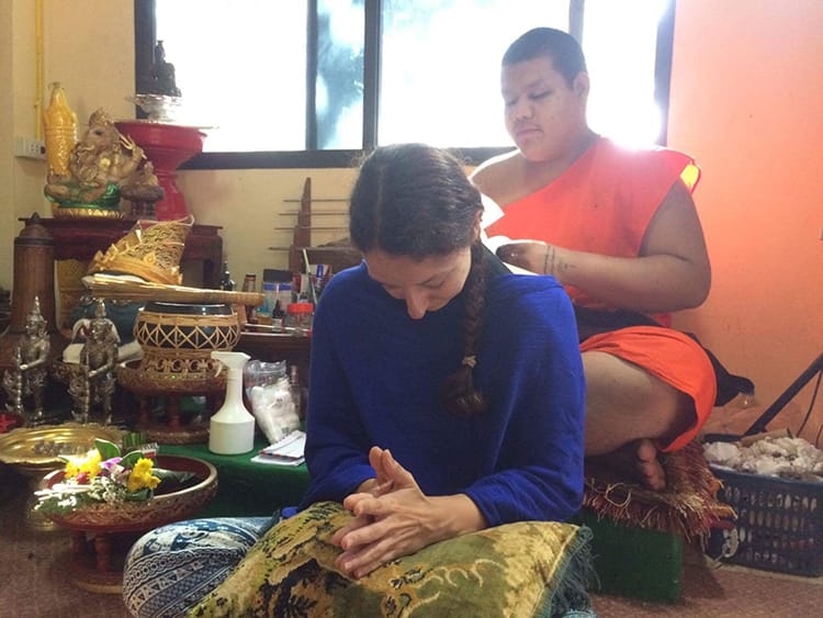 Michelle Della Giovanna from Full Time Explorer gets a sak yant tattoo from a Monk in Thailand