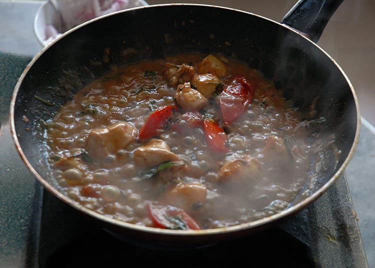 A Keralan style chicken curry cooking on the stove