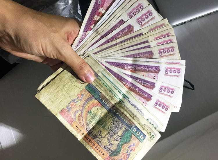 A handful of Burmese kyat which is the name for money in Myanmar