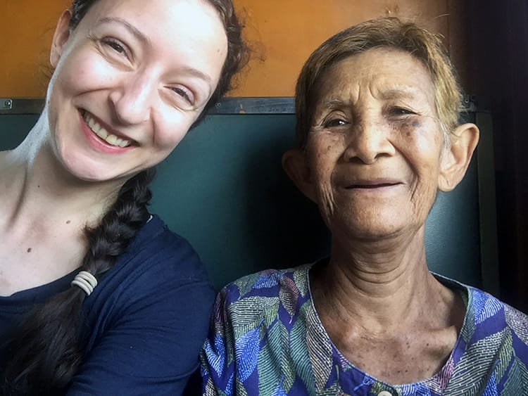 Michelle Della Giovanna from Full Time Explorer sits next to a wonderful women on the Thai Railways North Line train