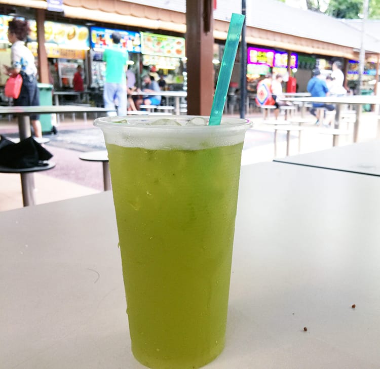 A sugarcane juice with lime in a Singapore hawker stall
