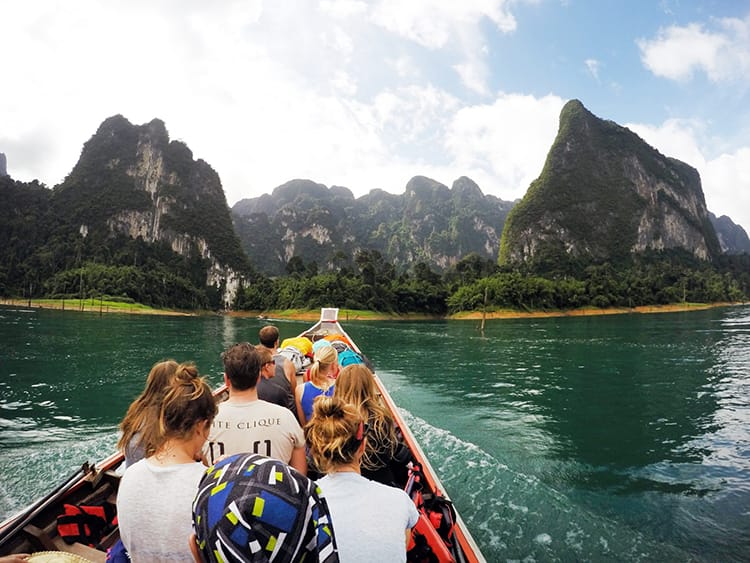 A long boat takes a group of tourists into Khao Sok National Park