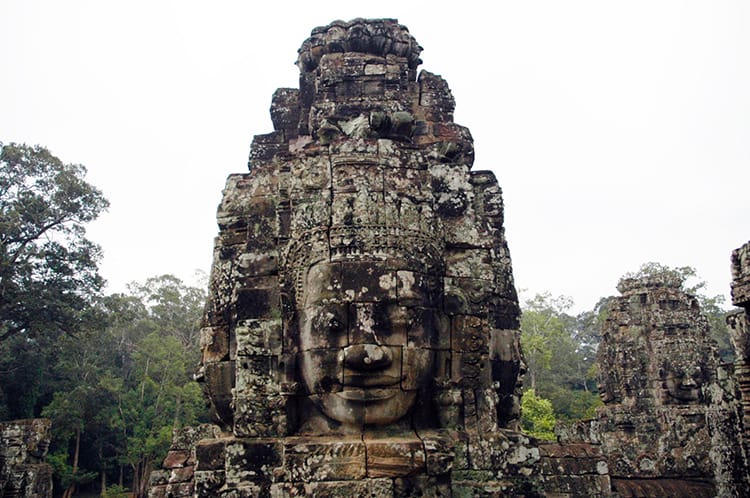 A large head carved out of stone at tone of the temples near Angkor Wat