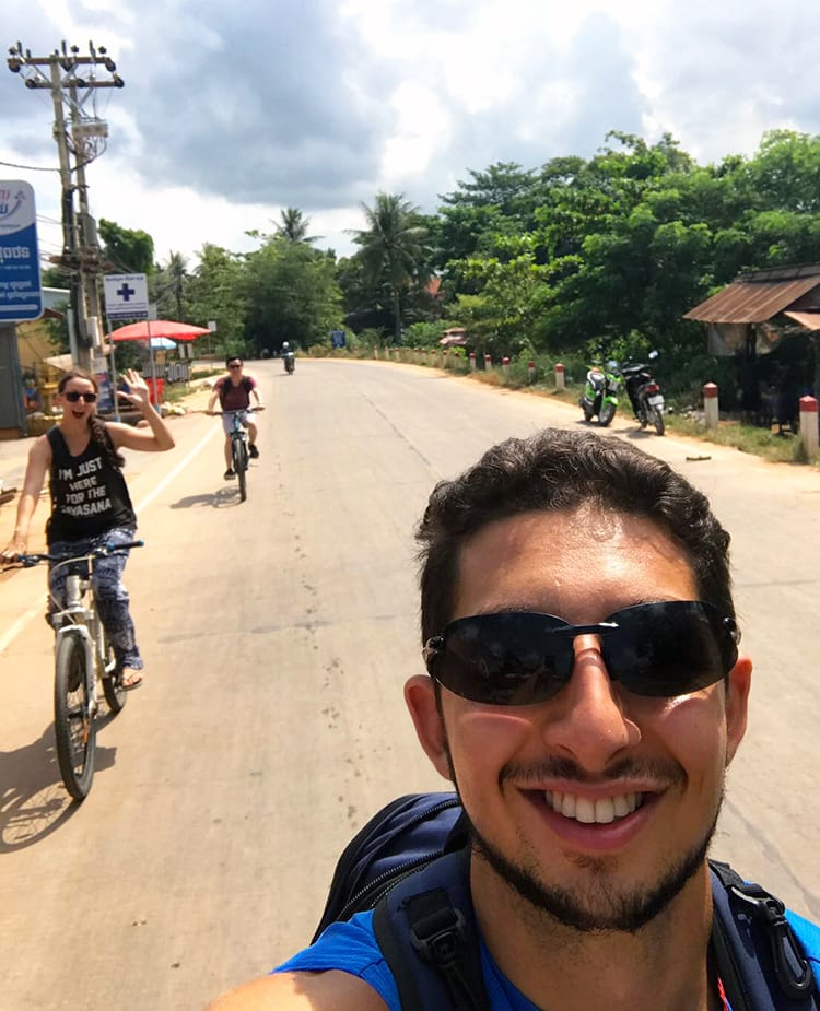 Michelle Della Giovanna from Full Time Explorer and two friends take a selfie while riding bikes to Tonle Sap Lake in Siem Reap, Cambodia