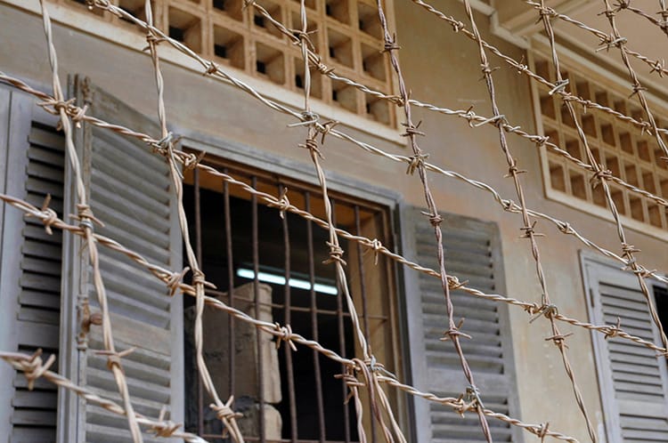 Barbed wire covers the second balcony at S21 Prison in Phnom Penh, Cambodia