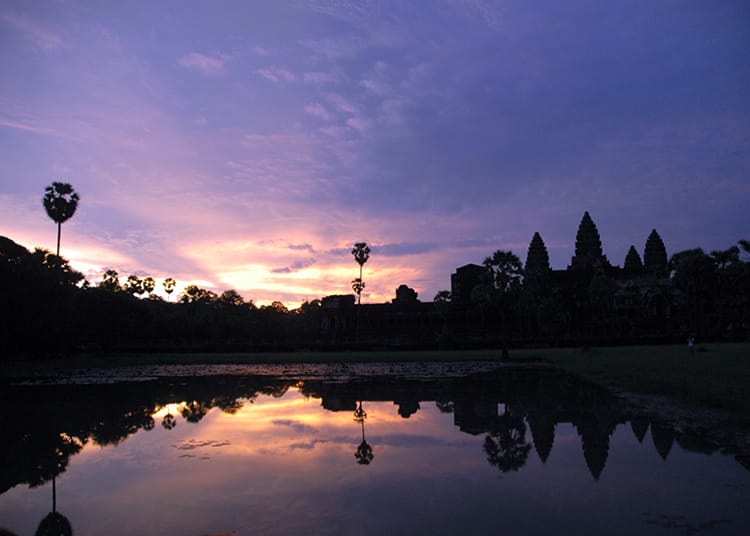 Siem Reap, Cambodia Angkor Wat Temple at sunrise with a purple sky and hot pink clouds