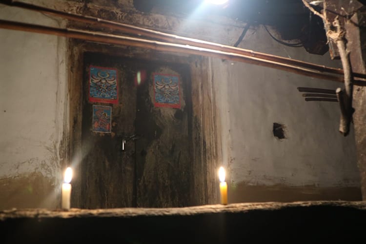 Candles light the entryway of a home in Tangting Village, Nepal during Tihar