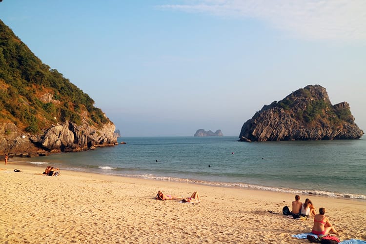 People sunbathing at a beach on Cat Ba Island, Vietnam