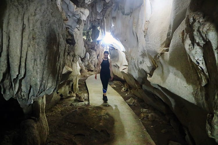 Michelle Della Giovanna from Full Time Explorer walks through Trung Trang Cave on Cat Ba Island in Vietnam