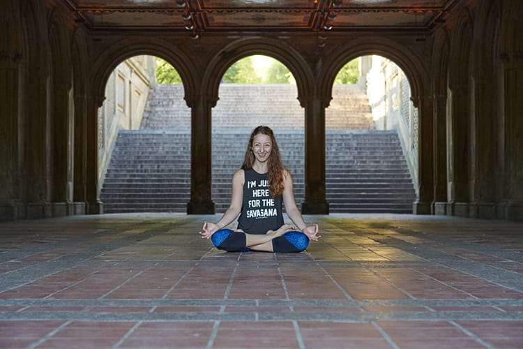 Michelle Della Giovanna from Full Time Explorer sits in a seated yoga position in Central Park