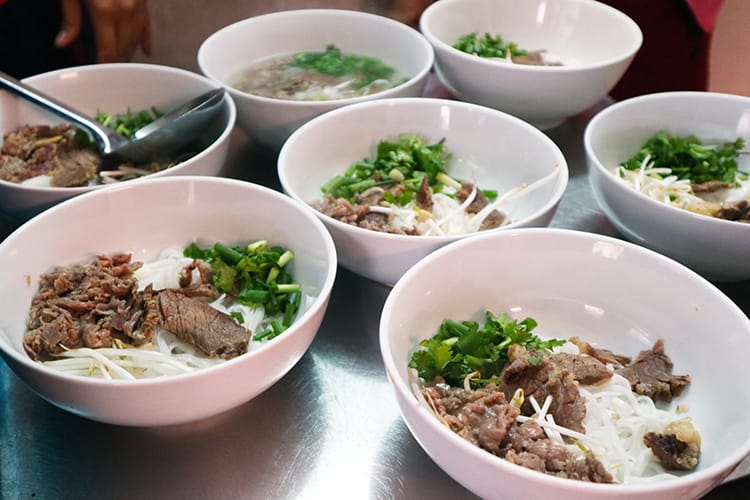 Several bowls of Vietnamese pho sit on a table during a Vietnamese cooking class in Hanoi