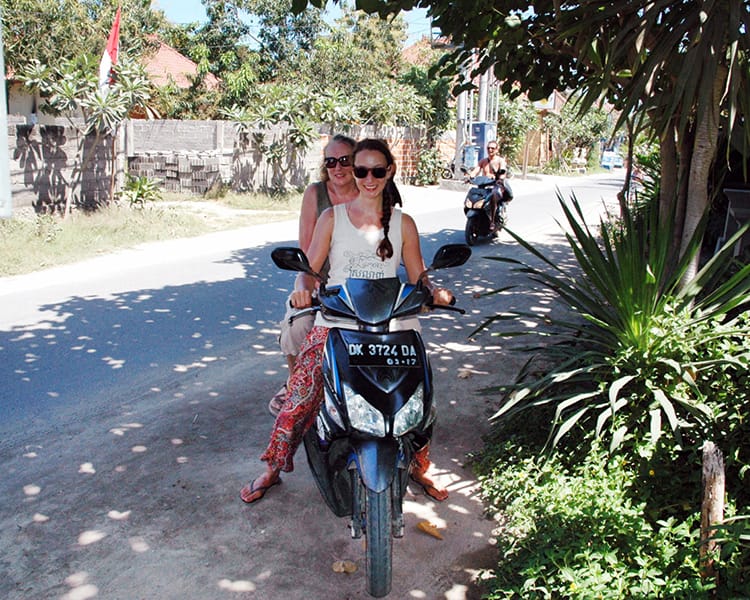 Michelle Della Giovanna from Full Time Explorer and her mom ride a scooter around Bali