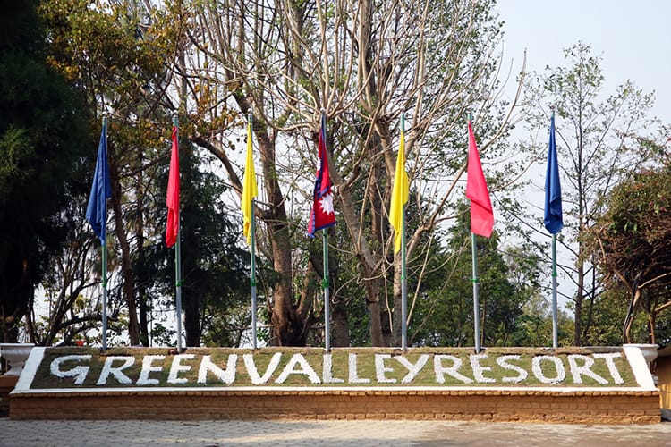 Flags hang at the entrance to Green Valley Resort