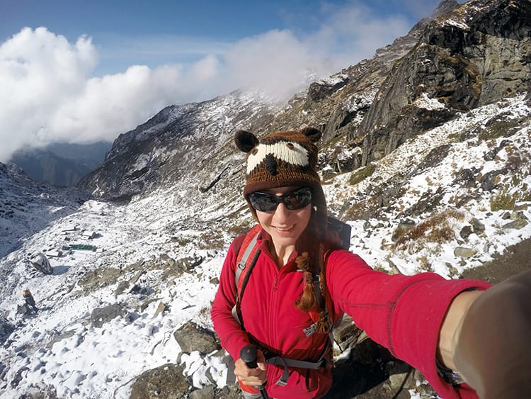 Michelle Della Giovanna from Full Time Explorer takes a selfie on the way back from Mera Peak while wearing an owl hat