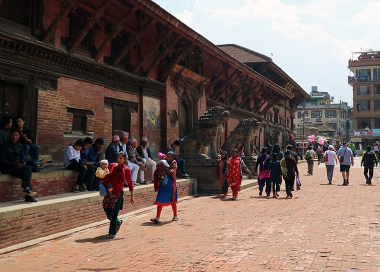 Nepali women walk in front of the Patan Museum