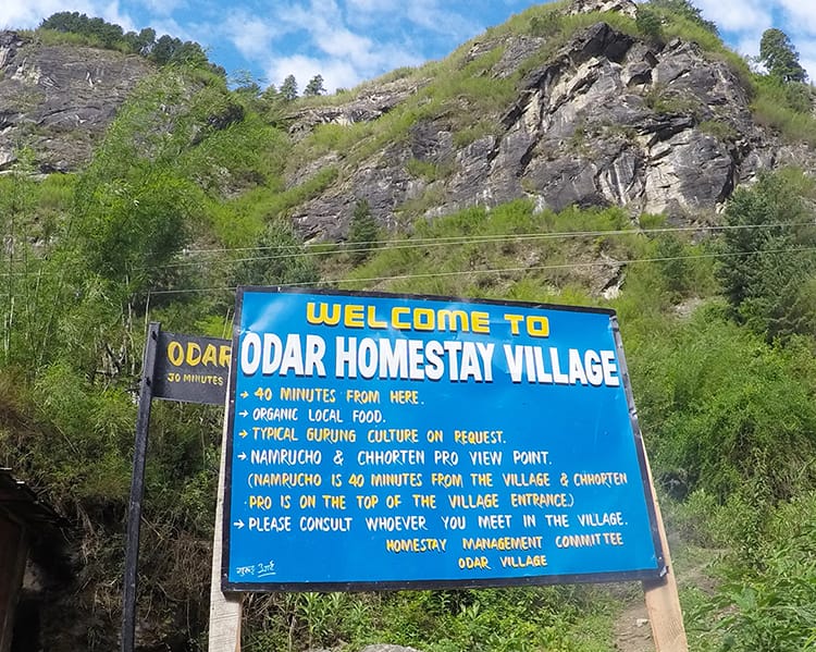 A sign on the Annapurna Circuit that says "Typical Gurung culture on request... please contact whoever you meet in the village."