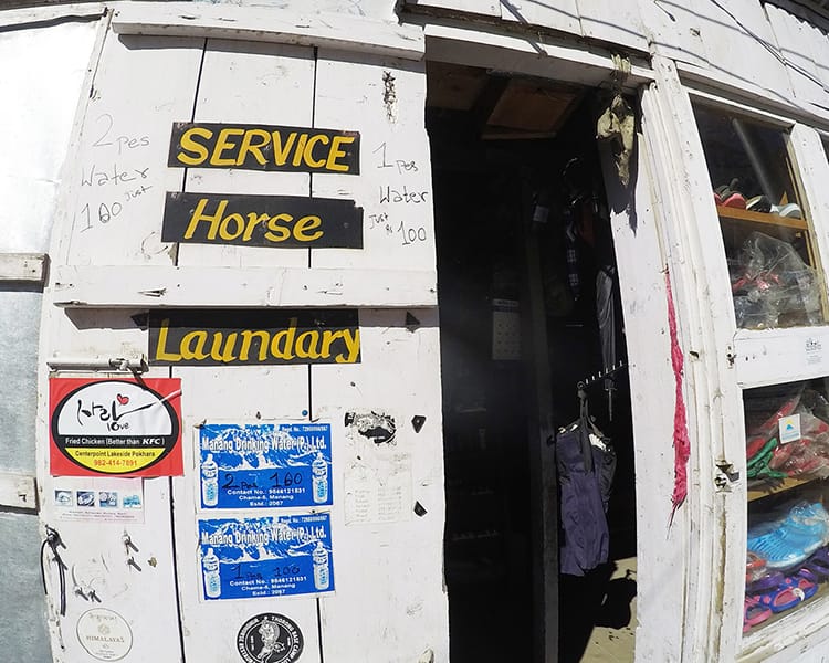 A sign on the Annapurna Circuit that says "Service: Horse Laundry"