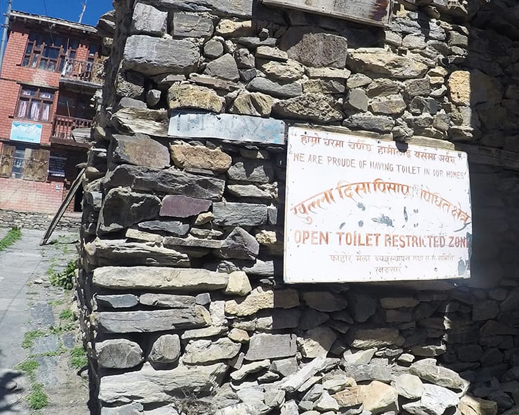 A sign on the Annapurna Circuit that says "Open toilet restricted zone"