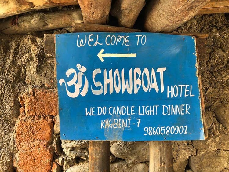 A sign on the Annapurna Circuit that says "Candle light dinner"