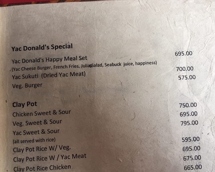 A menu on the Annapurna Circuit for Yak Donalds that says "served with a side of happiness"
