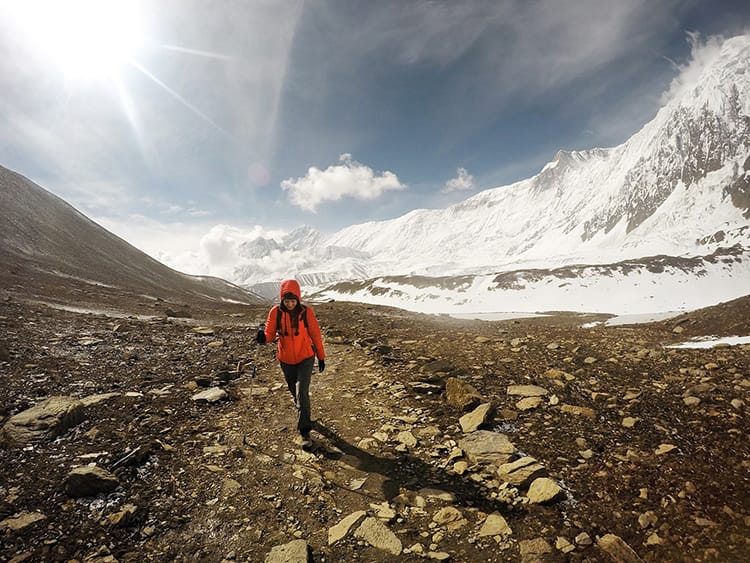 Michelle Della Giovanna from Full Time Explorer walks toward Tilicho Lake on the Annapurna Circuit in Nepal