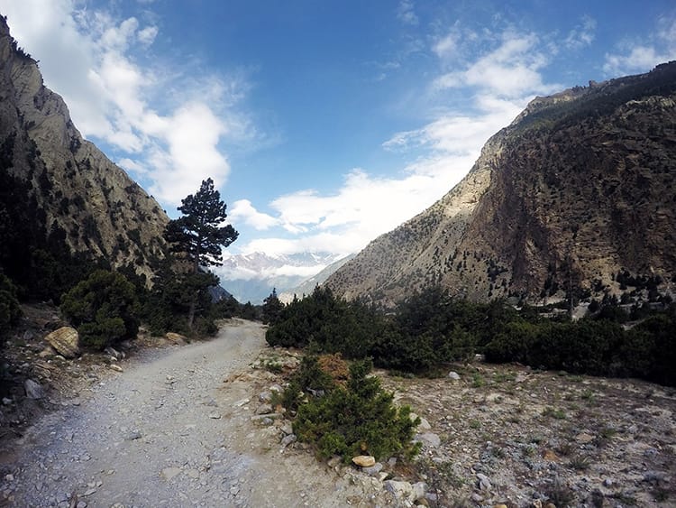 A gravel and dirt road along the river on the Annapurna Circuit