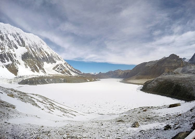 Tilicho Lake frozen over and covered in a blanket of snow