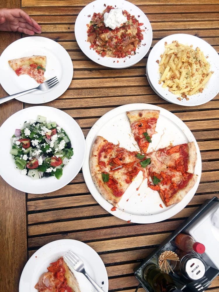 Pizza, nachos, and a salad from Mezze by Roadhouse