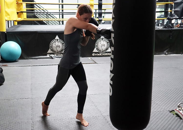 Michelle Della Giovanna from Full Time Explorer working on cross punches on a heavy bag