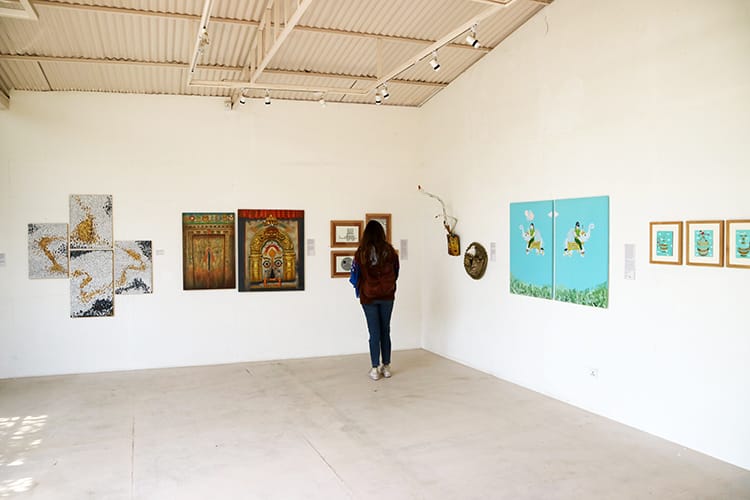 A woman stands and admires art at Gallery Mcube in Patan, Nepal