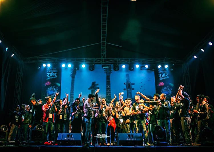 Young adults celebrate on the stage of the Nepal Music Festival