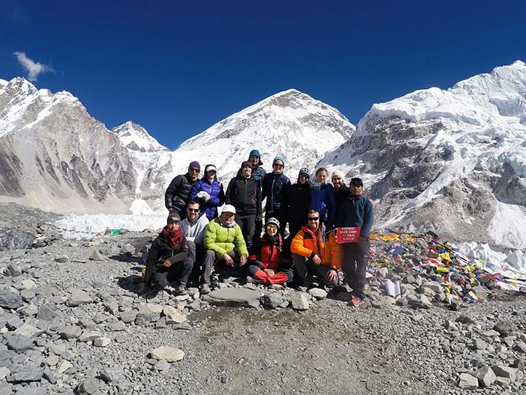 A group tour stands at Everest Base Camp in Nepal