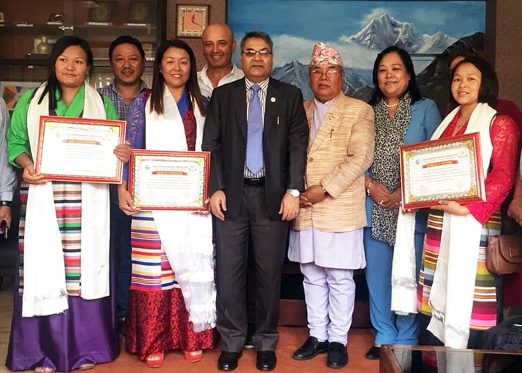 Female Trekking Guides in Nepal are given an award by a minister