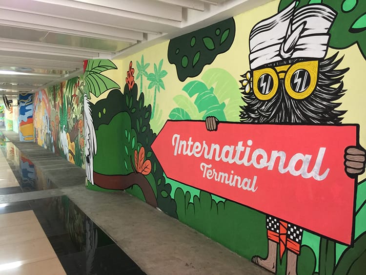 A large wall mural at the international terminal in Bali