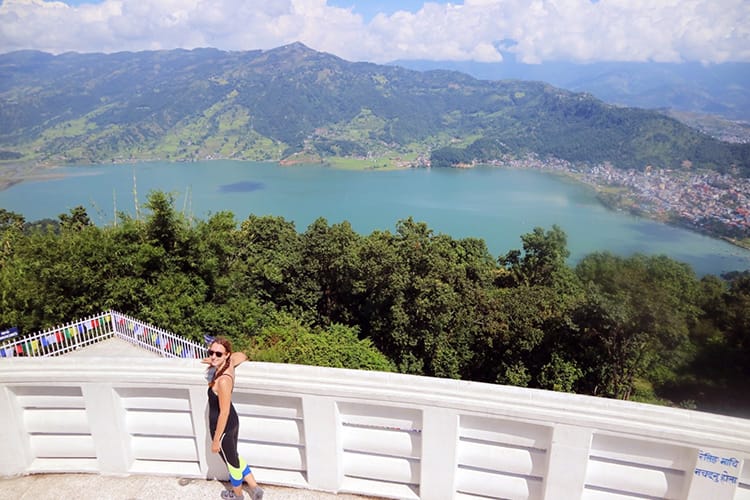 Michelle Della Giovanna from Full Time Explorer standing at the World Peace Pagoda in Pokhara, Nepal
