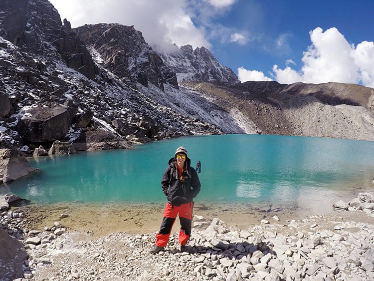 Michelle Della Giovanna from Full Time Explorer stands in front of Gokyo Lake on the way to Everest Base Camp