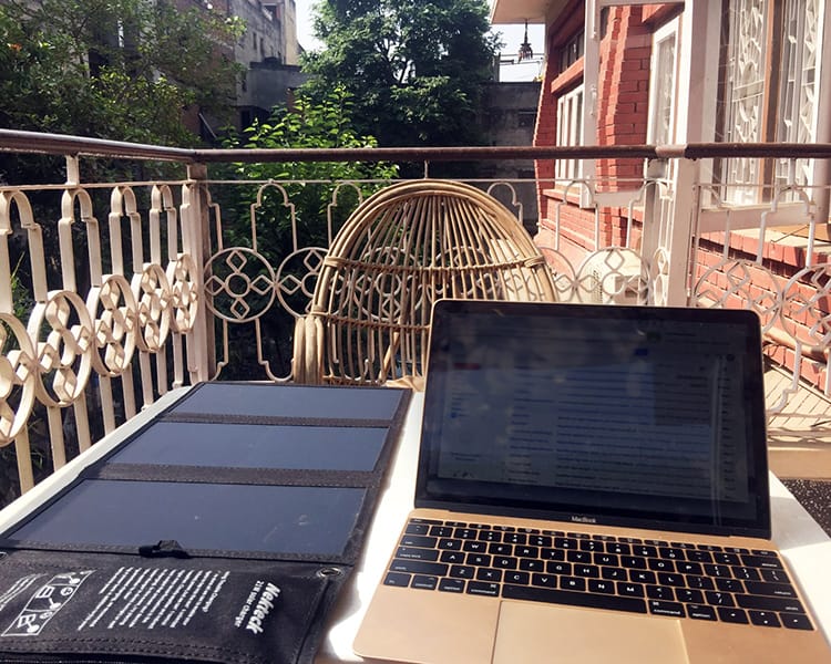 A laptop computer on a desk on a balcony in Nepal
