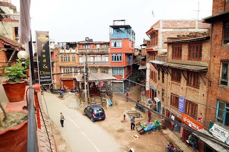 An overhead view of a street in Bhaktapur with cars parked