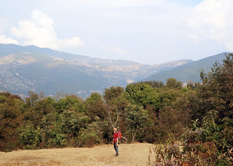 Michelle Della Giovanna from Full Time Explorer standing in a small field on the way from hiking Bhaktapur to Nagarkot