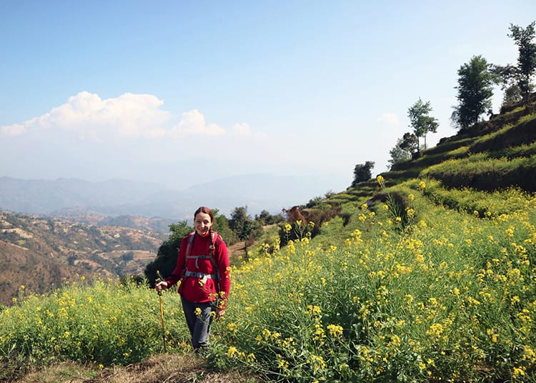 Michelle Della Giovanna from Full Time Explorer stands in a mustard field close to Dhulikhel in January