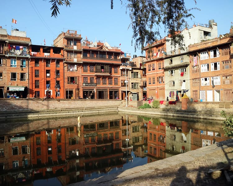 The snake pond in Bhaktapur reflects the buildings surrounding it