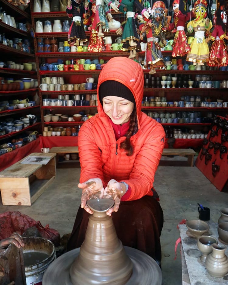 Michelle Della Giovanna from Full Time Explorer uses a pottery wheel in Bhaktapur