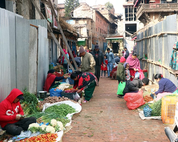 Vendors sell produce on the streets of Bhaktapur by laying down blankets on the road