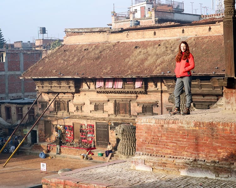 Michelle Della Giovanna from Full Time Explorer stands on the Nyatapola Temple in Taumadhi Square